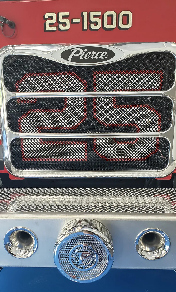 Front grille close-up showing number panel and lower bumper fittings