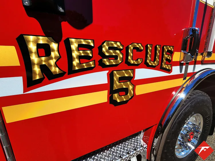 Body side close-up showing raised rescue unit lettering and striping