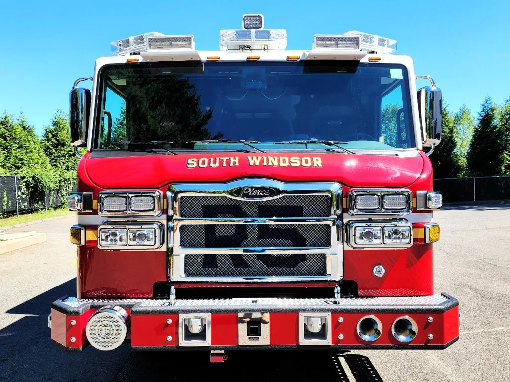 Head-on front view showing grille, bumper intakes, and warning lights