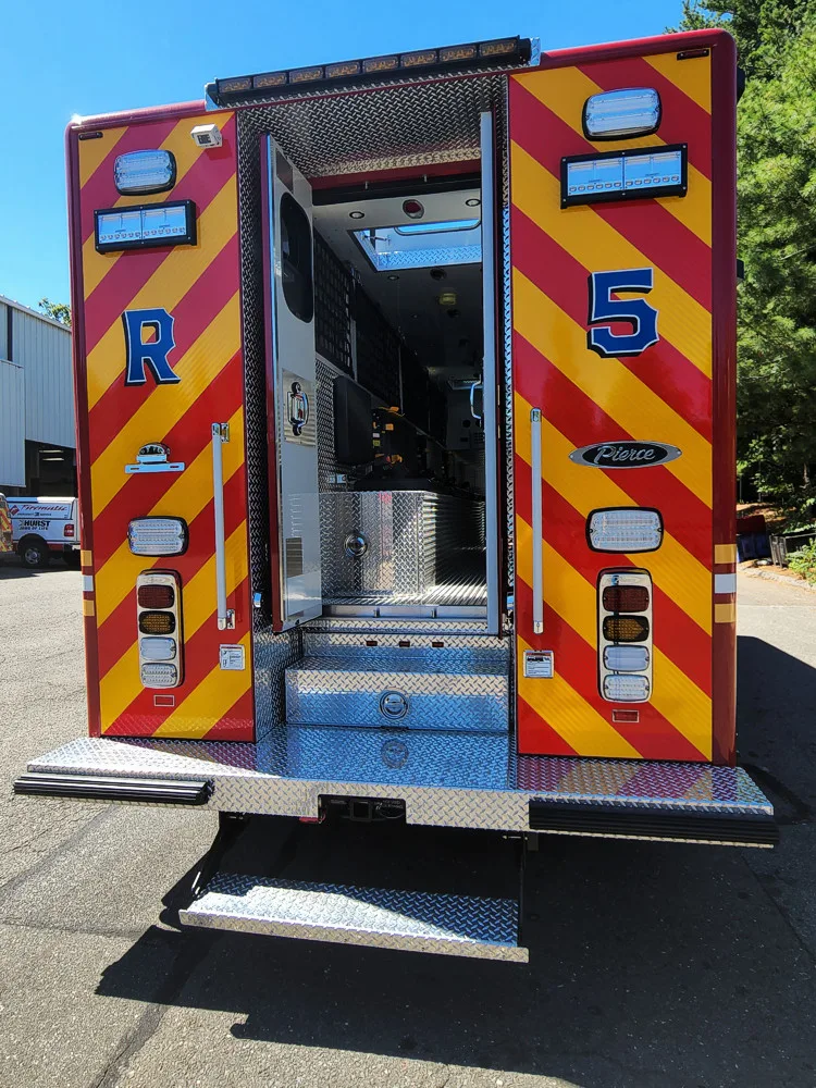 Rear-right view with rear doors open showing walk-in compartment access