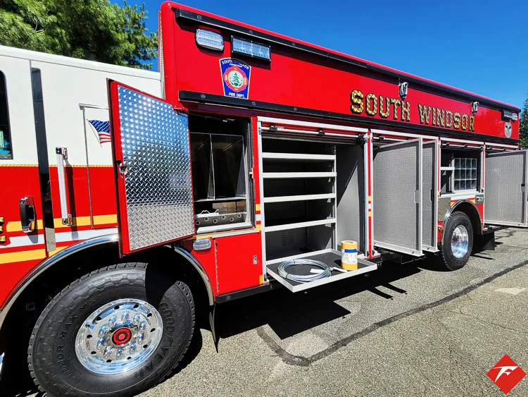 Driver-side profile with open compartments showing rescue body storage