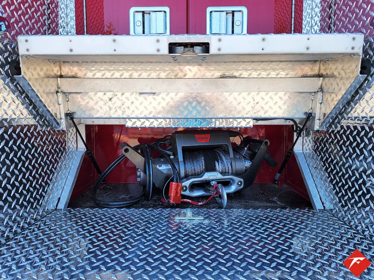 Open lower compartment showing slide-out tray with mounted rescue tools