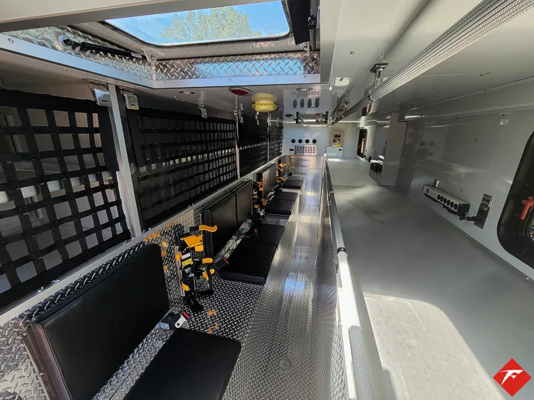 Walk-in rescue interior view showing aisle and side equipment racks