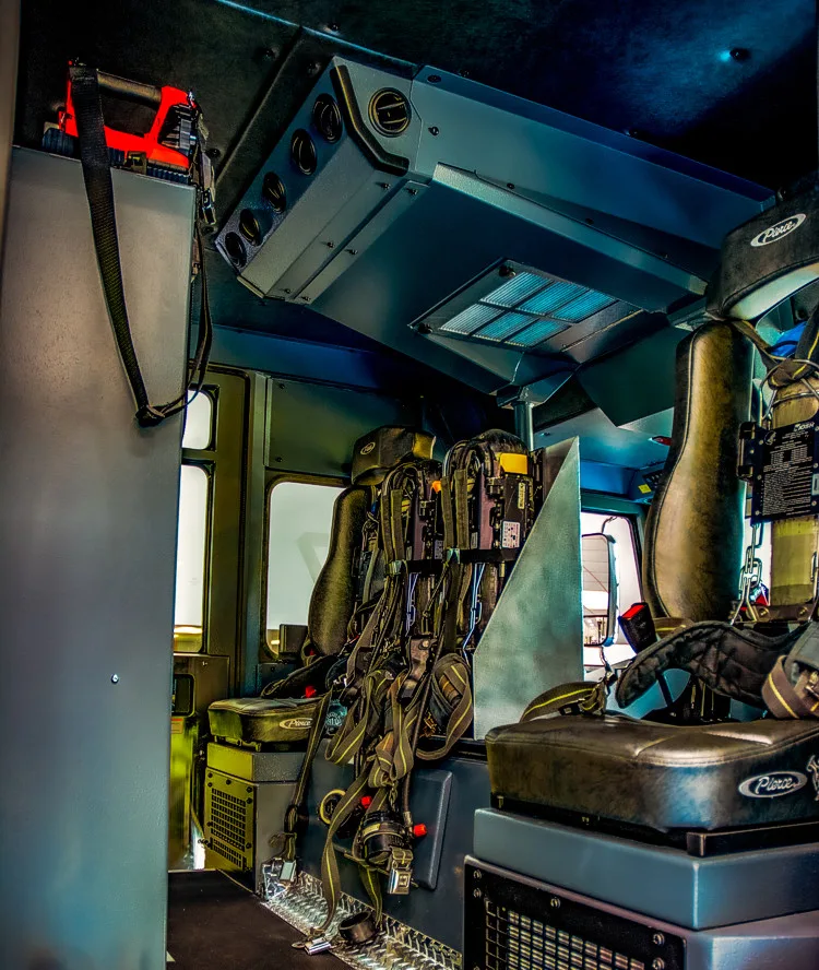 Cab interior rear crew area showing seats, seat mounts, and center aisle