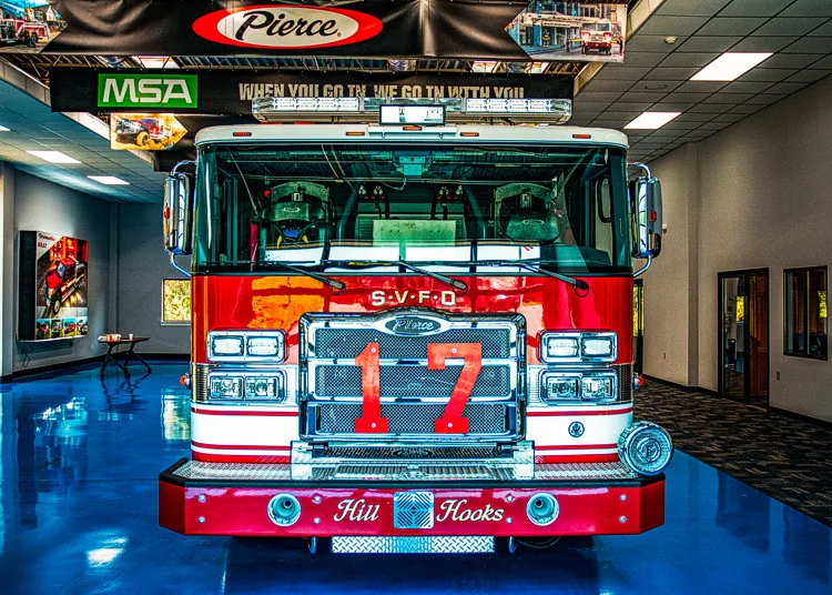 Front exterior view indoors showing grille, bumper, and warning lights