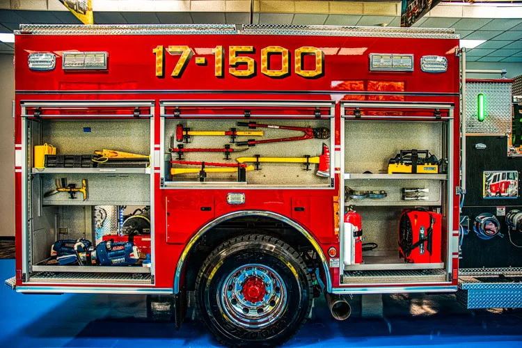 Driver-side profile with open compartments showing tools and equipment shelves