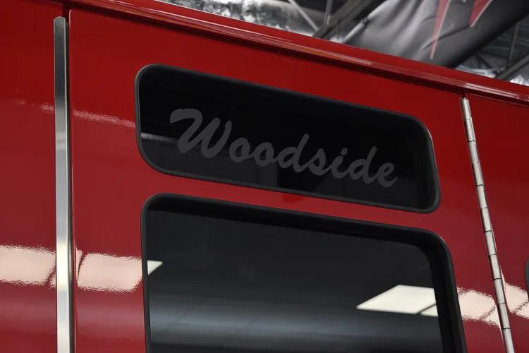 Cab window close-up showing script lettering on dark glass panel