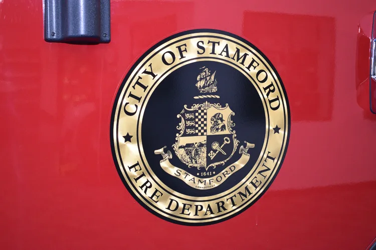 Cab door close-up showing circular city seal on red panel