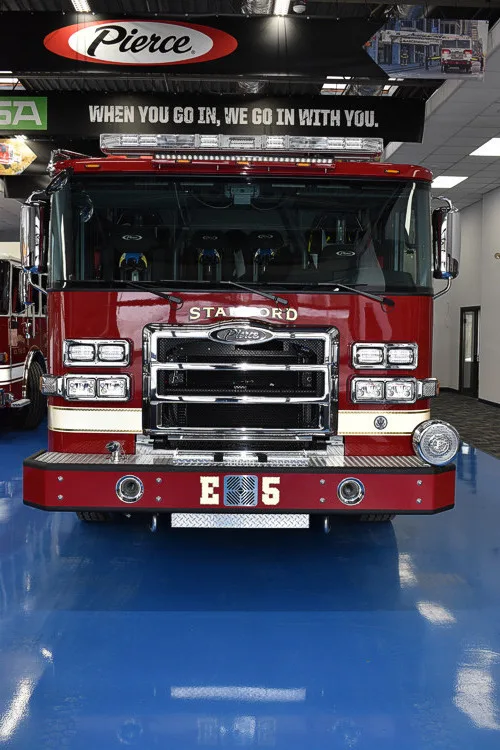 Head-on front view showing grille, bumper intake, and warning lights