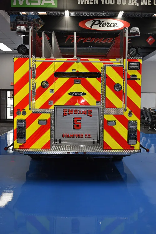 Rear view showing red-and-yellow chevrons and tailboard compartment area