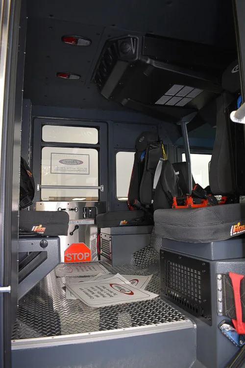 Rear crew interior view showing seat backs and aisle through the cab