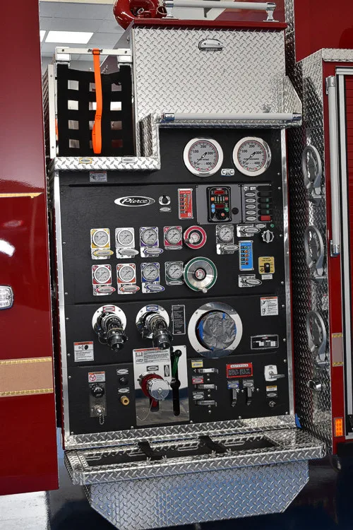 Pump panel close-up showing gauges, valves, and labeled control knobs