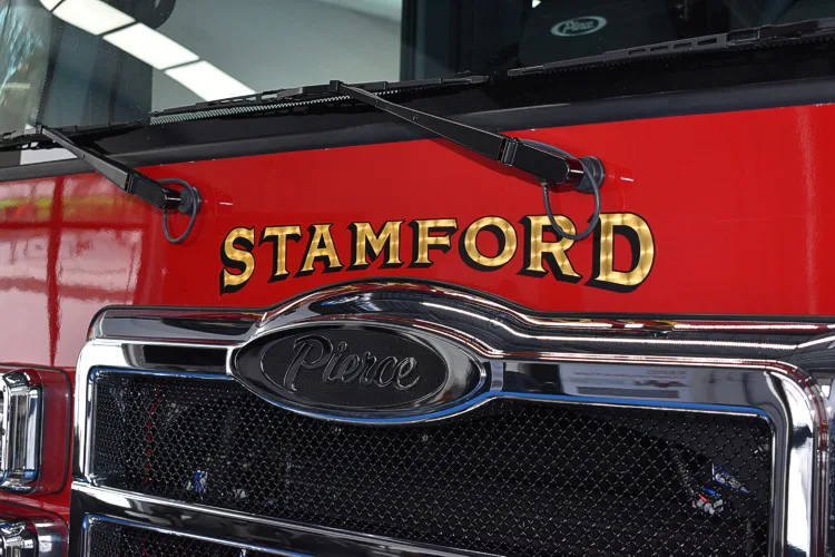 Front grille close-up showing city lettering and black mesh pattern
