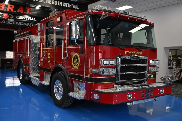 Pumper front-left exterior profile showing side compartments and cab
