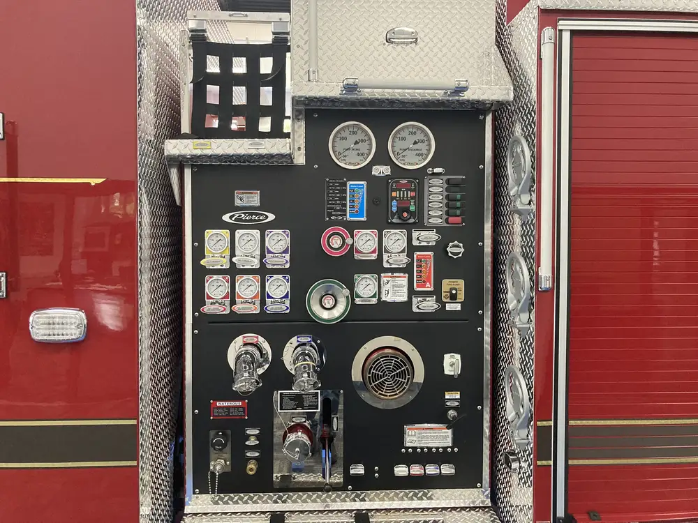 Pump panel close-up showing gauges, valves, and intake controls