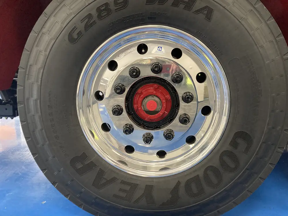 Front wheel close-up showing tread pattern and lug bolts