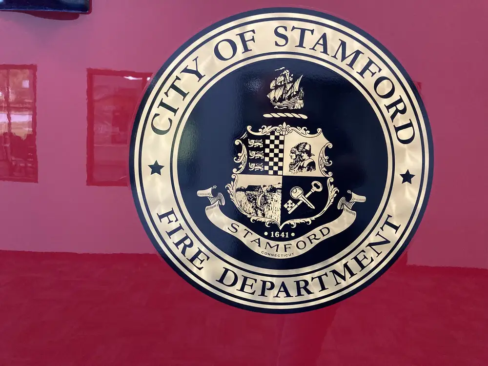 Cab door close-up showing city fire department seal on red panel