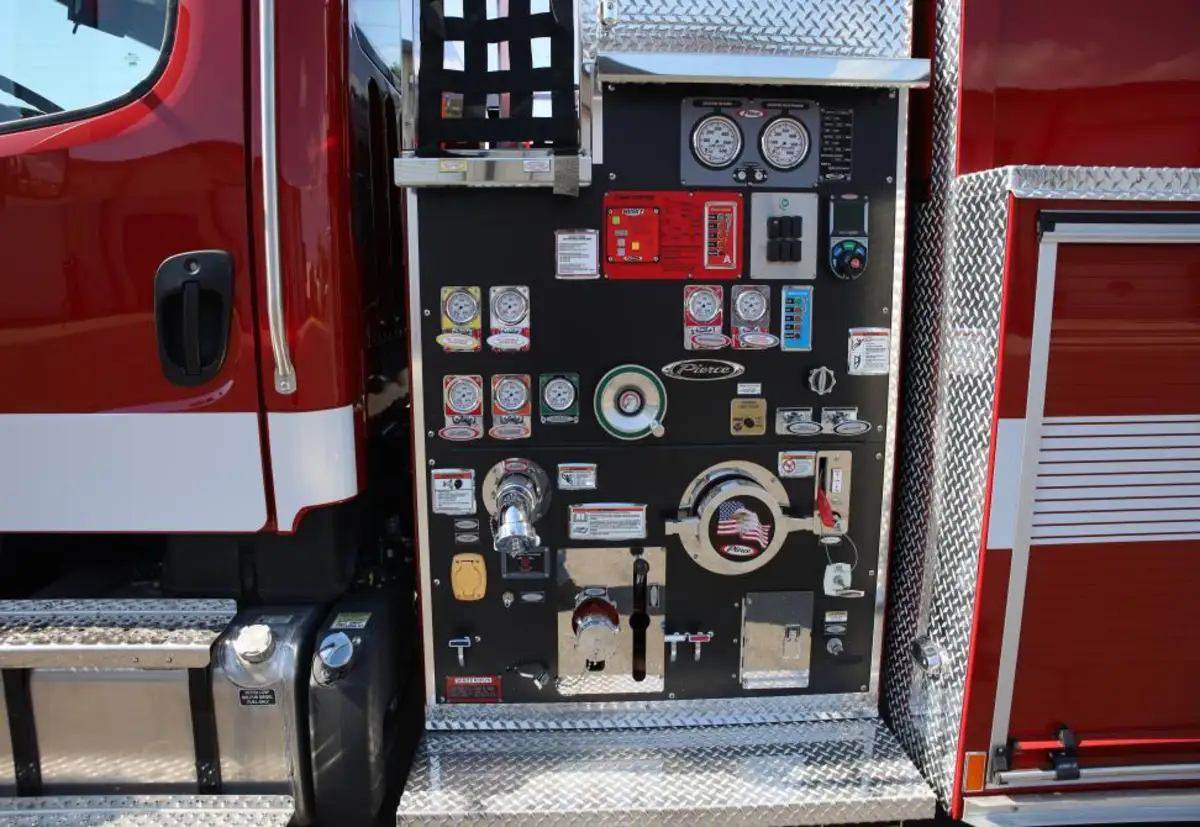 Pump panel close-up view showing gauges, valves, and intake connections