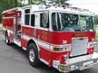 Pumper front-left exterior view showing enclosed cab and side compartments