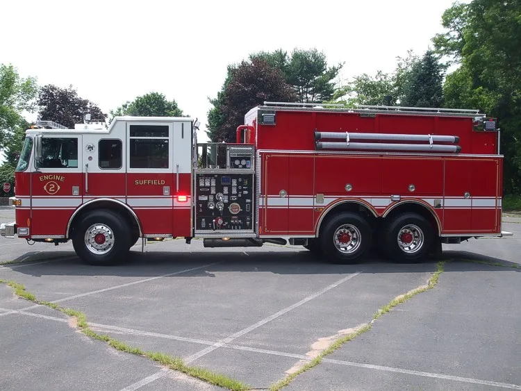 Driver-side full profile showing tandem wheel layout and midship pump panel