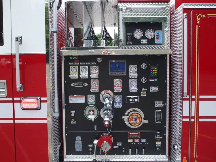 Pump panel close-up showing gauges, intake controls, and discharge valves