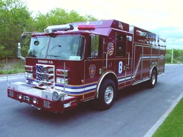 Front-left exterior view showing bumper, cab, and long body
