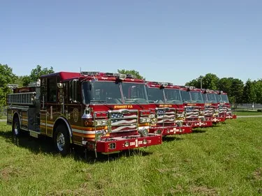 Lineup view of multiple pumpers showing front ends and side profiles