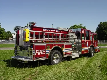 Rear-right exterior view showing side hosebed rails and rear body