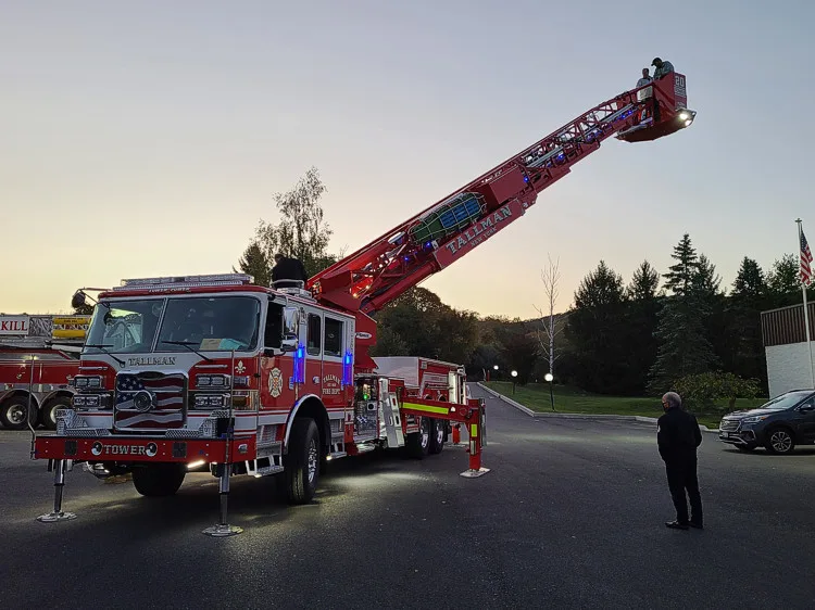Evening exterior view showing tower ladder with aerial raised