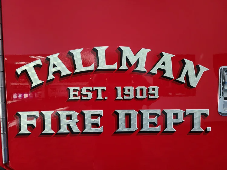 Body side close-up showing raised department script on red paint