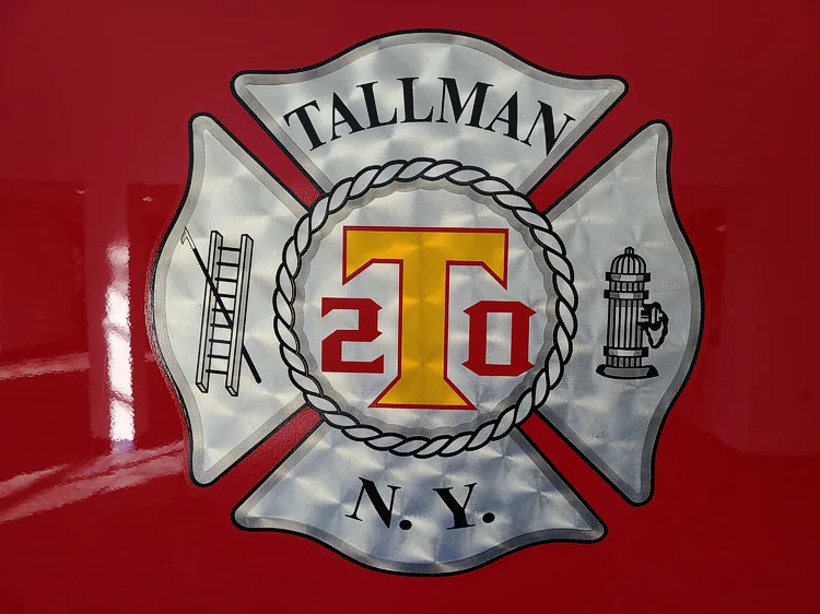 Cab door close-up showing silver department crest badge on red panel