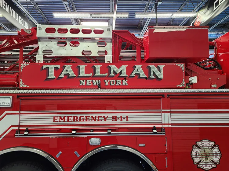 Body side close-up showing raised Tallman lettering on red panel