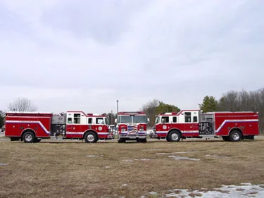 Wide side lineup view showing several pumper bodies and wheel areas