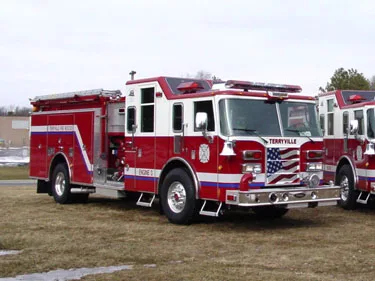 Single pumper front-left view in lineup showing bumper and side compartments