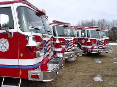 Close front-quarter lineup view showing bumpers, grilles, and front cab corners