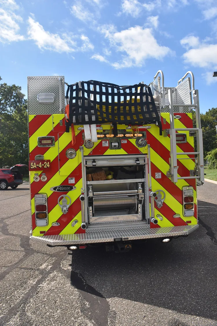 Rear view showing red-and-yellow chevrons and open rear center compartment