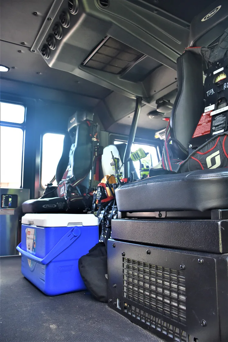 Cab interior side view showing rear seat and equipment bins