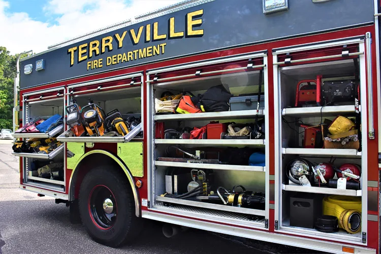 Driver-side profile with open compartments showing tools and shelf storage