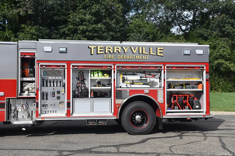 Driver-side full profile with open compartments showing equipment layout