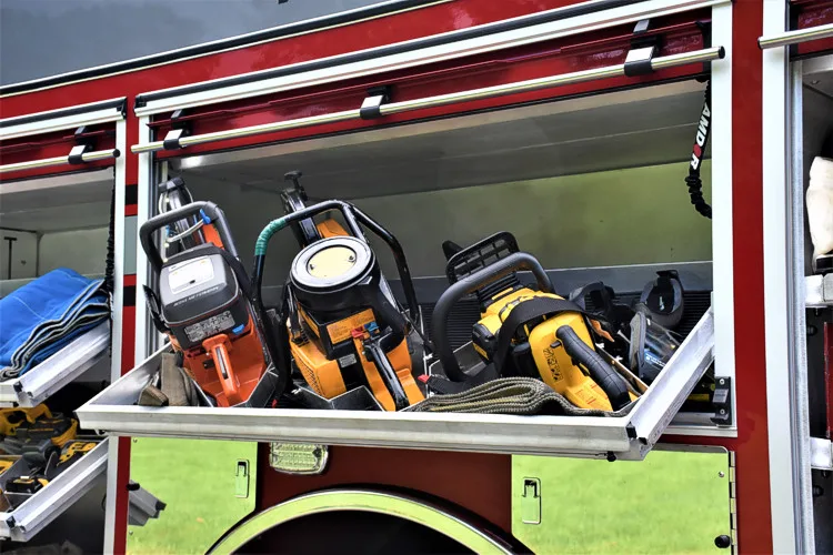Open side compartment close-up showing hand tools and nozzles