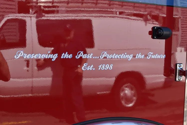 Body panel close-up showing cursive motto lettering on red section