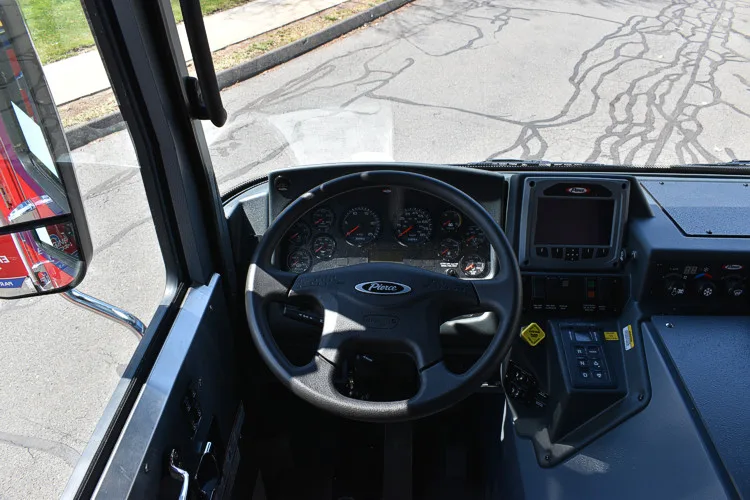 Driver cockpit view showing steering wheel, dashboard, and center controls