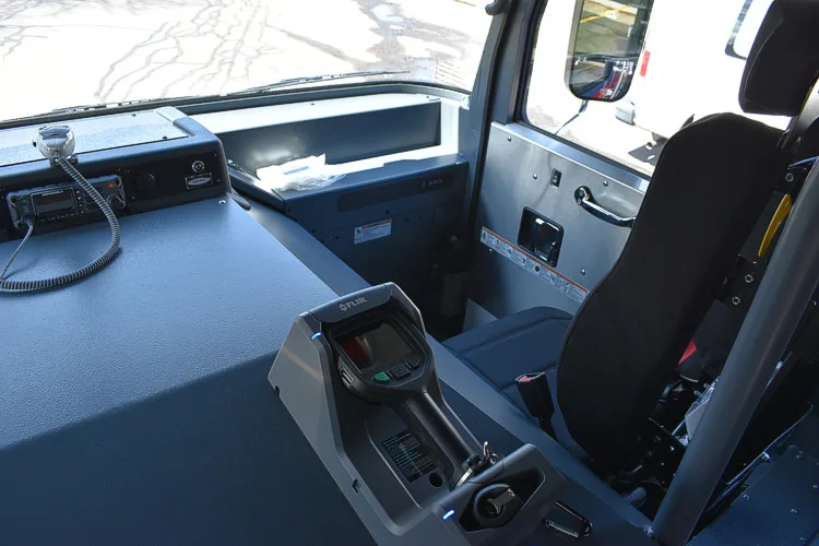 Cab interior side view showing front seat, console, and dash shelf