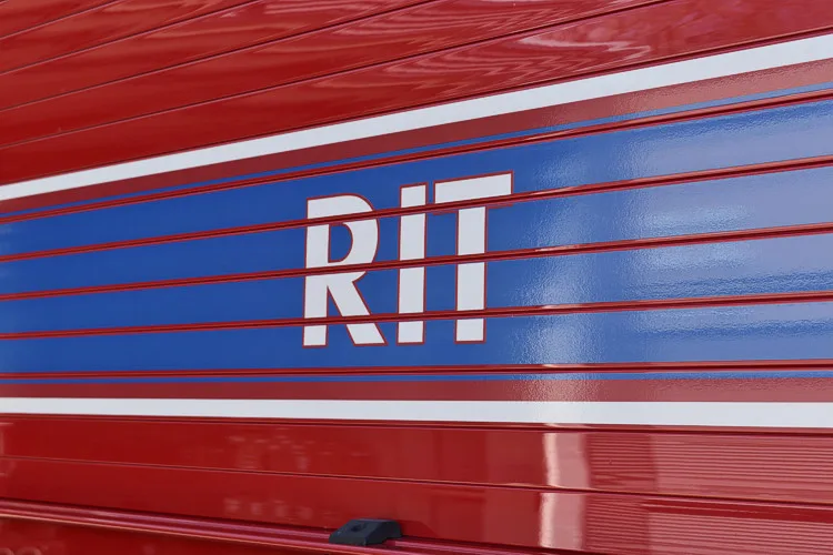 Body lettering close-up showing large white letters on blue stripe