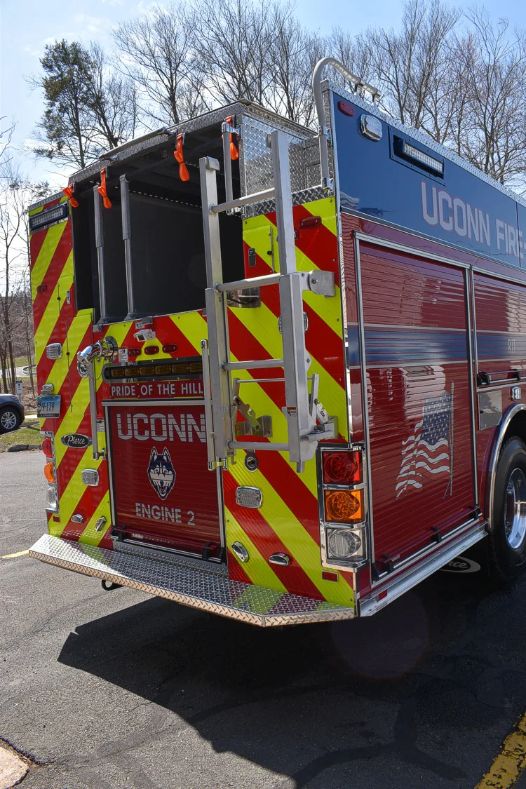 Rear-left exterior view showing chevrons and rear door hardware