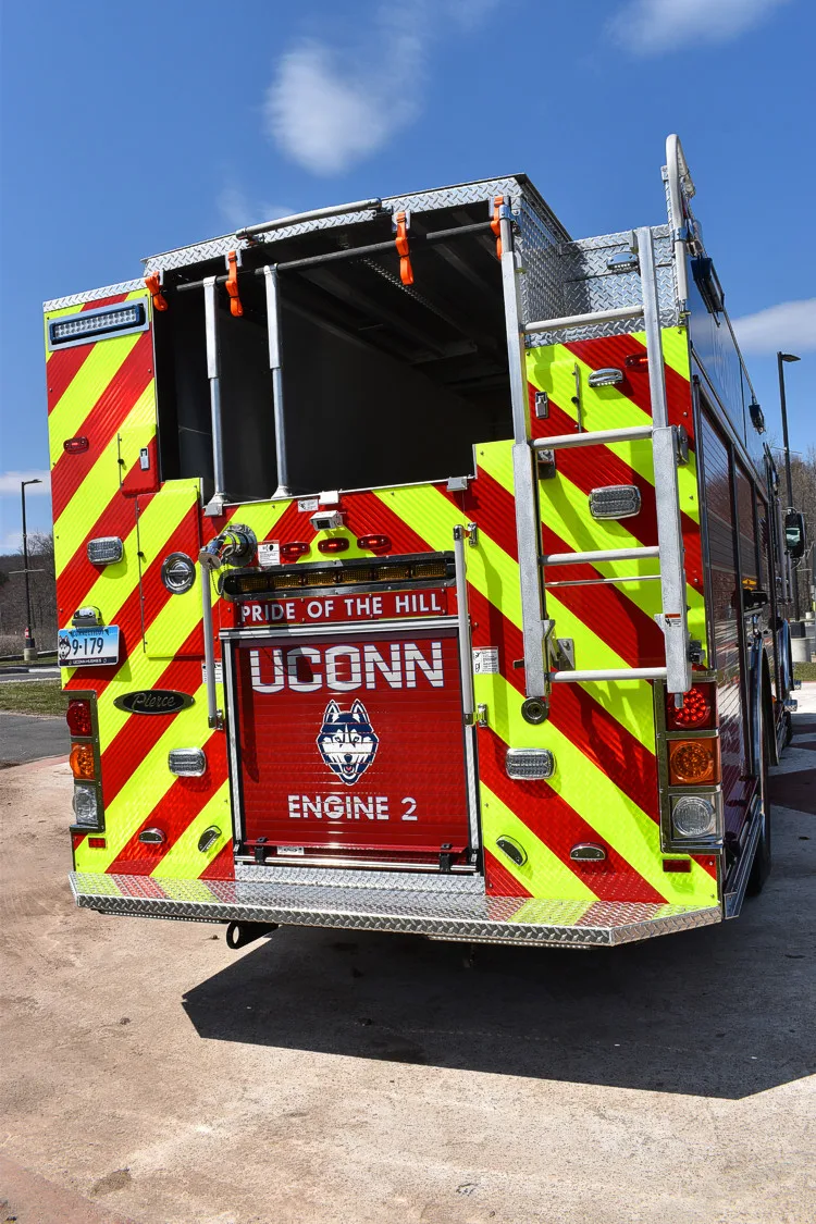 Rear view showing full chevron panel, rear lights, and hosebed edge