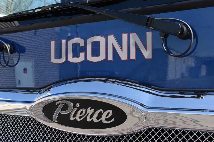 Front grille close-up showing Pierce badge on dark mesh panel