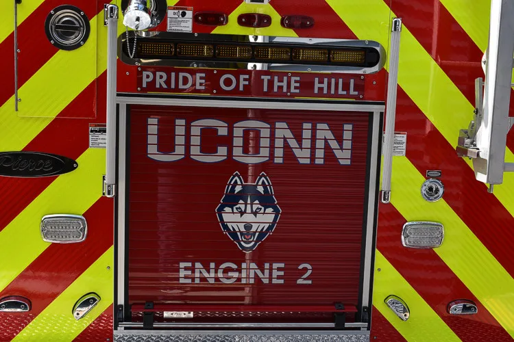 Rear view showing red-and-yellow chevrons and raised lettering panel