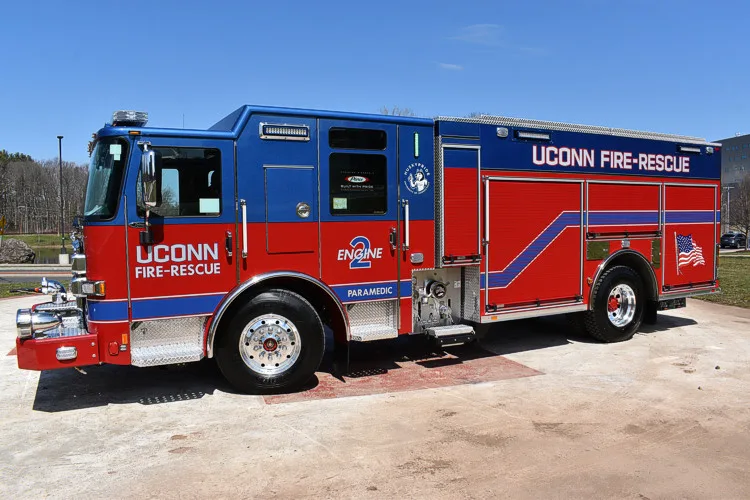 Driver-side profile view showing side stripes and body lettering