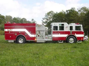 Driver-side profile view showing pump panel and side body compartments